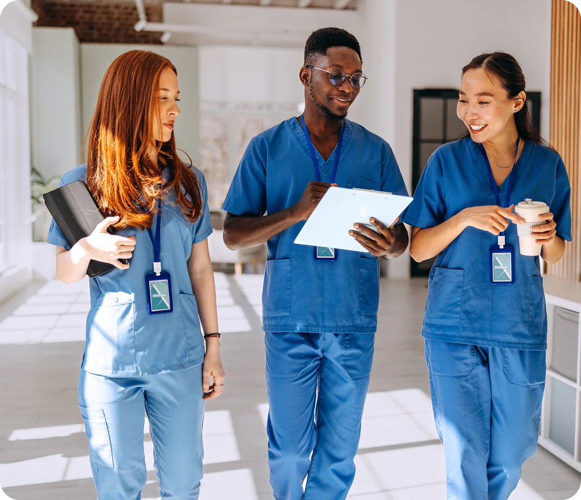 Nurses collaborating in hospital corridor